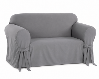 gray loveseat covered with a fitted slipcover on a white background