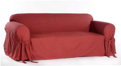 red sofa covered with a fitted slipcover on a white background